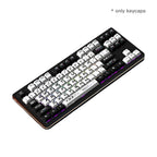 Top view of black and white custom mechanical keycaps with futuristic tech legends on a backlit gaming keyboard.