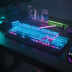 A high-end mechanical keyboard with transparent blue crystal keycaps glowing with RGB lighting on a dark cyberpunk-themed desk setup.