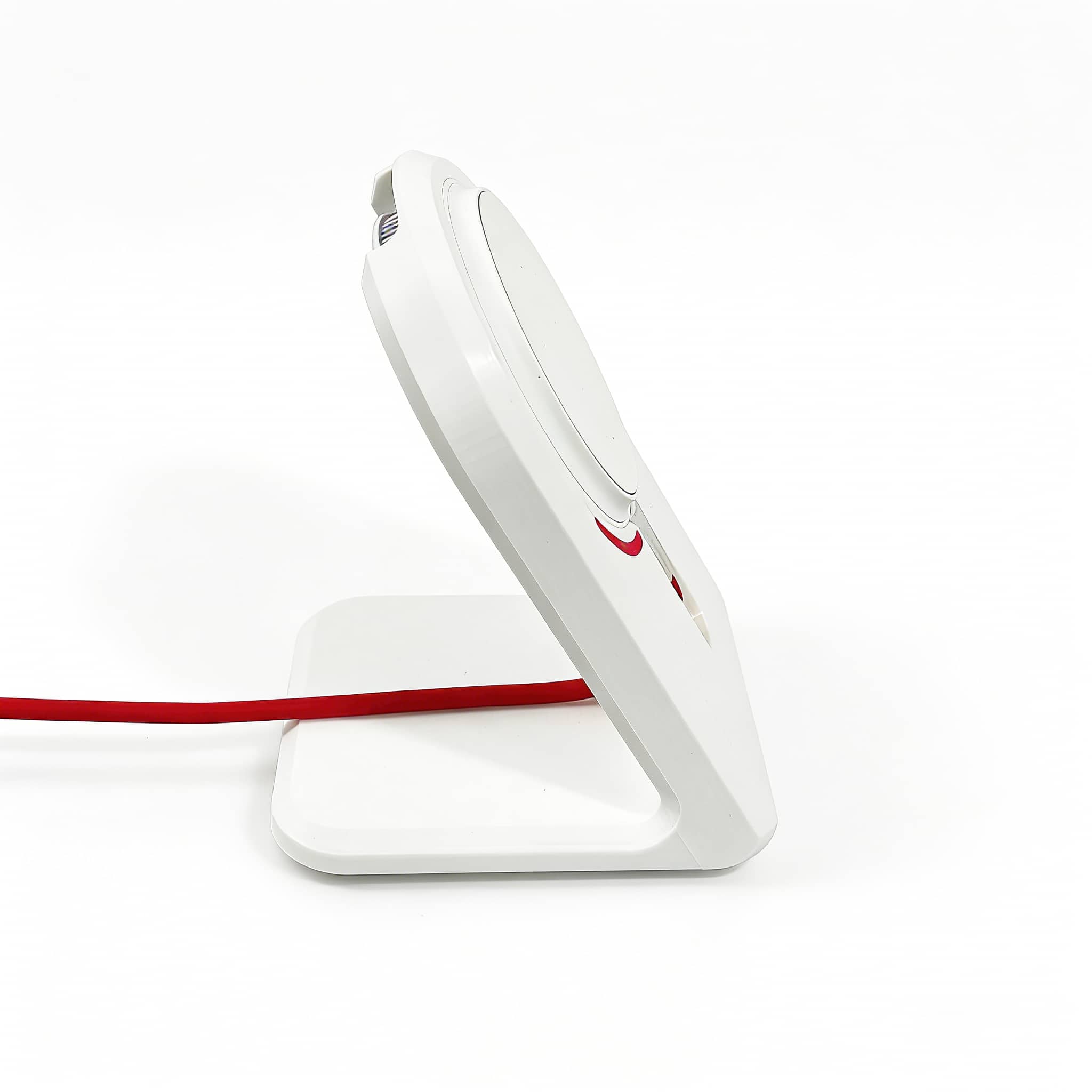 Side-profile view of the OnePlus AirVOOC 50W Magnetic Charger perfectly docked in our custom white stand, with a sleek red cable routed neatly.