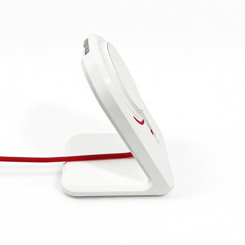 Side-profile view of the OnePlus AirVOOC 50W Magnetic Charger perfectly docked in our custom white stand, with a sleek red cable routed neatly.